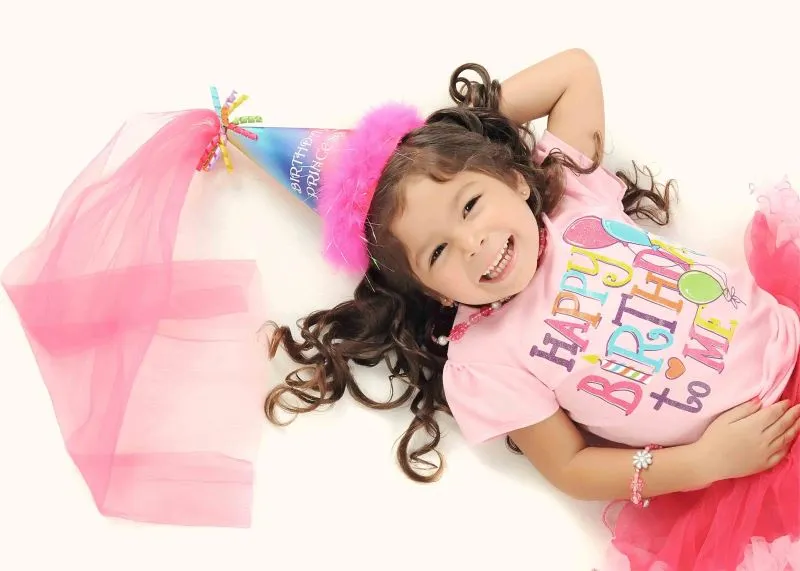 A photo of a birthday girl lying on the floor