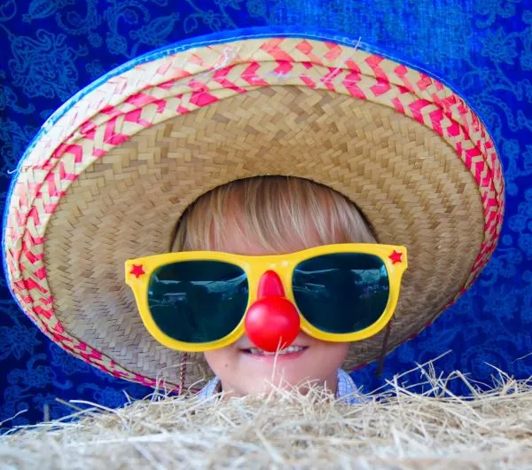 A photo of a boy wearing a hat and sunglasses