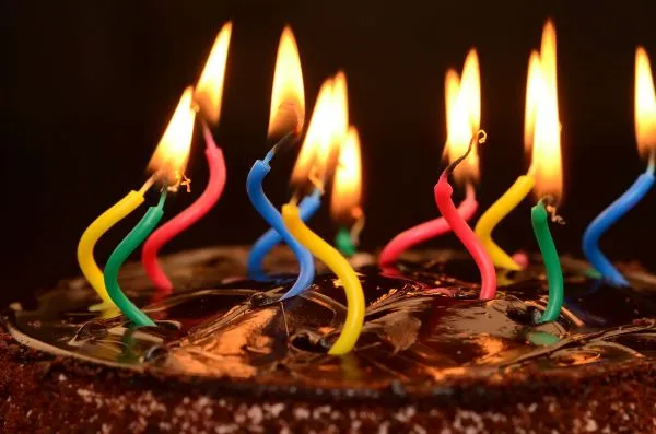 A photo of a birthday cake with lit up candles