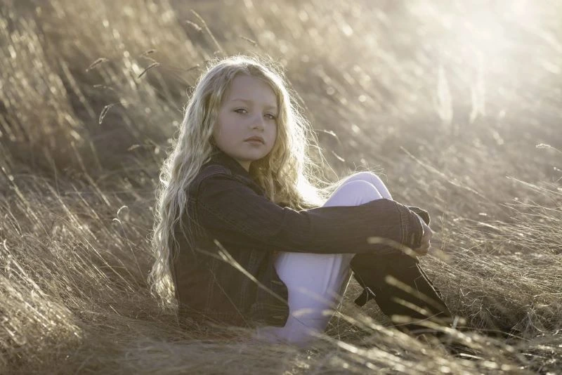 A young girl sat on the ground