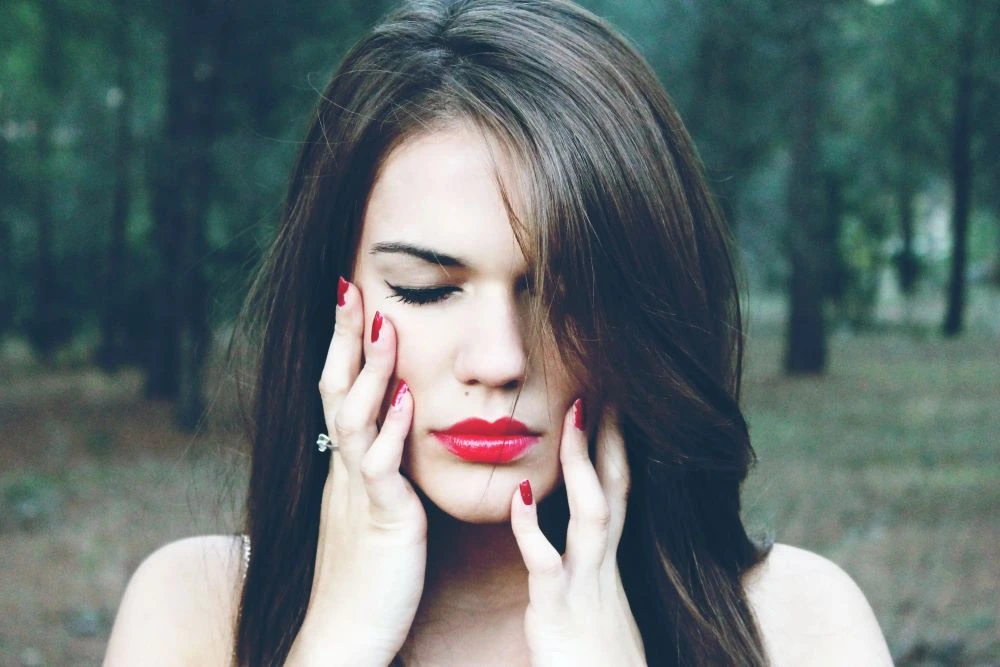 A photo of a woman holding her face